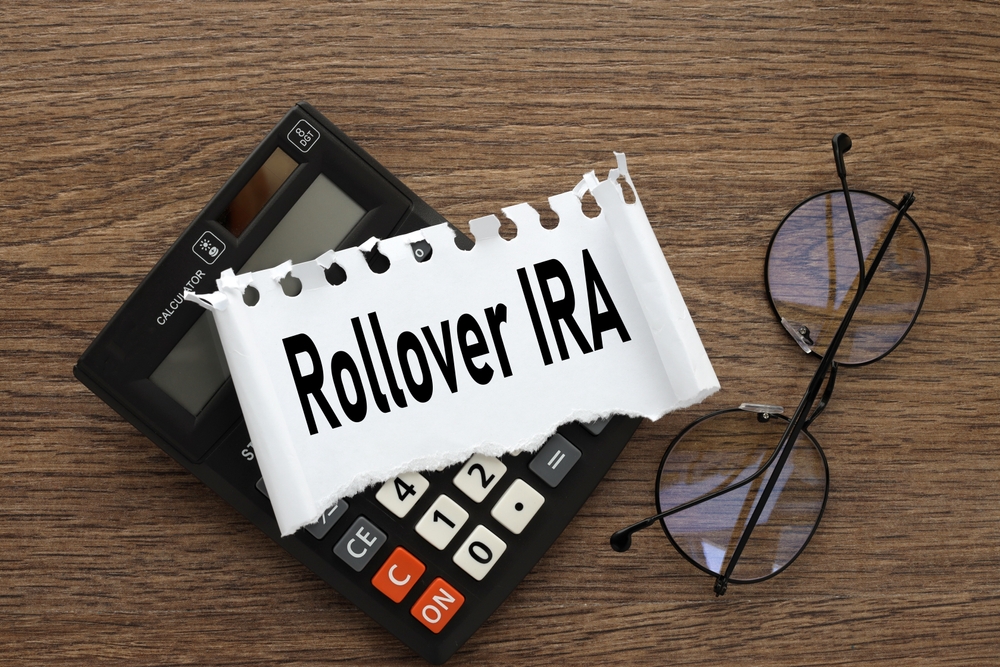 Rollover,Ira.,Black,Calculator,And,Torn,Paper,With,Text